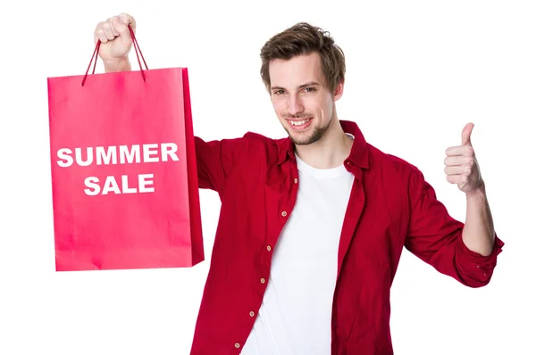 Happy man shopping with his thumb up — Stock Photo, Image