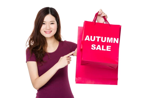 Woman  pointing  at  shopping bags — Stock Photo, Image
