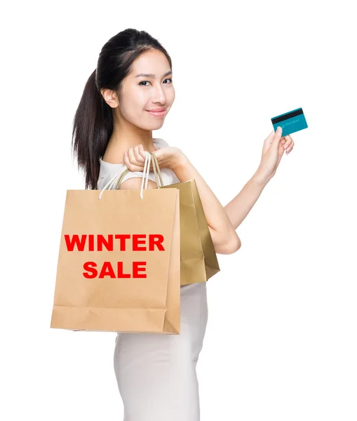 Woman holding credit card and bags — Stock Photo, Image