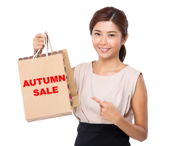 Asian woman point to shopping bags — Stock Photo, Image