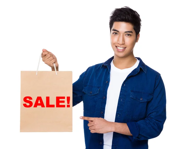 Asian man point to shopping bag — Stock Photo, Image