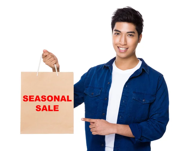 Asian man point to shopping bag — Stock Photo, Image