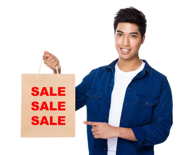 Asian man point to shopping bag — Stock Photo, Image