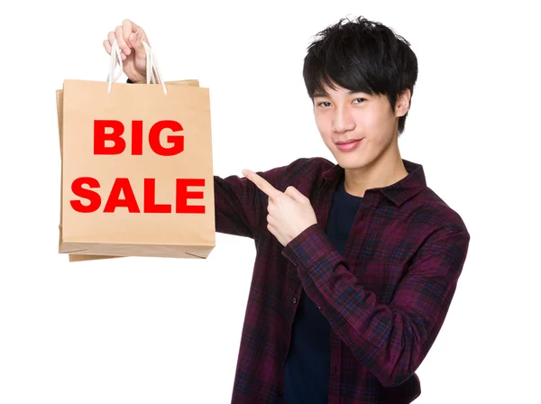 Asian man point to shopping bags — Stock Photo, Image