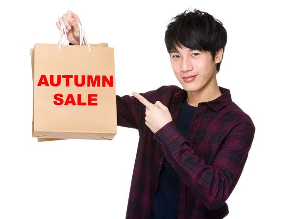 Asian man point to shopping bags — Stock Photo, Image