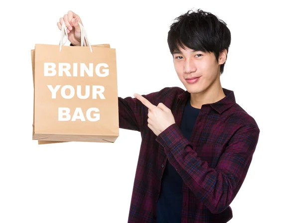 Asiático homem apontar para compras sacos — Fotografia de Stock