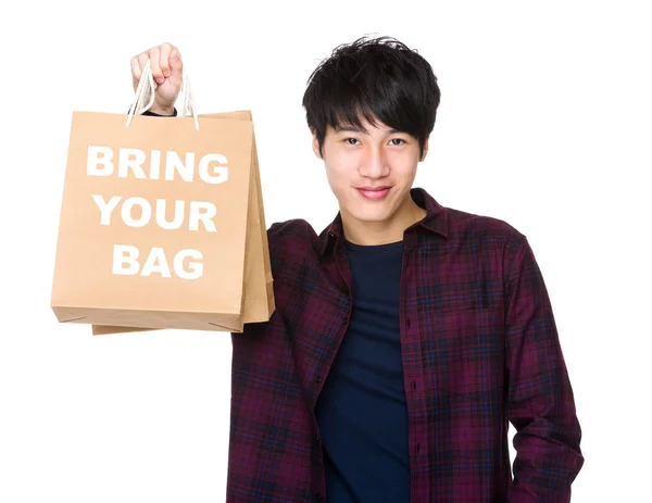 Asiático homem segurando sacos de compras — Fotografia de Stock
