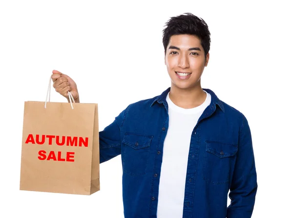 Man in blue shirt with shopping bag — Stock Photo, Image