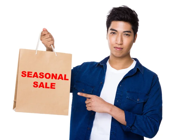 Asian man point to shopping bag — Stock Photo, Image