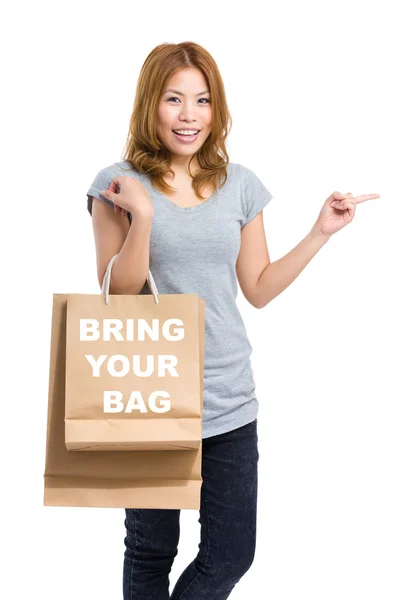 Woman point aside with shopping bags — Stock Photo, Image