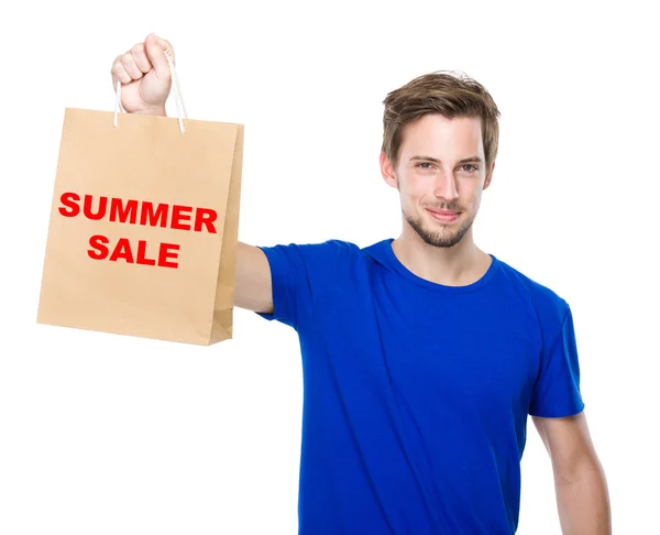 Joven hombre guapo con bolsa de compras —  Fotos de Stock