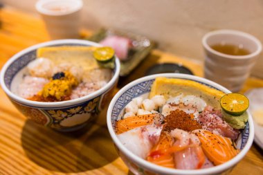 Lezzetli Japon pilav kasesi ve çeşitli sashimi deniz ürünleri.