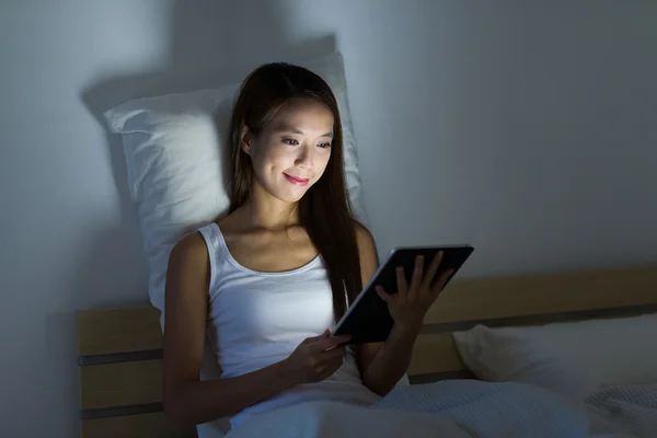 Wanita membaca dengan tablet di tempat tidur — Stok Foto