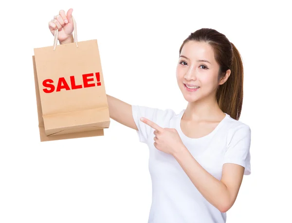 Woman with finger point to shopping bags — Stock Photo, Image