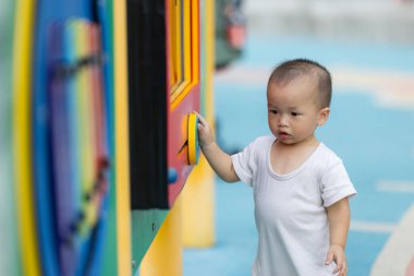 Sevimli bebek parkta tek başına yürüyor.