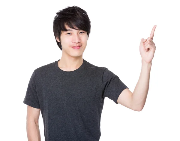 Asijský mladík, ukazující prst nahoru — Stock fotografie