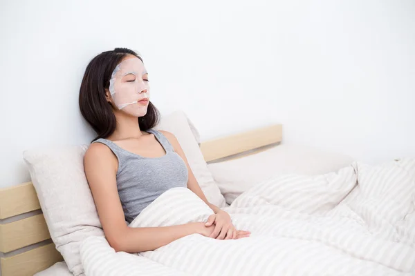 Woman doing facial paper mask — Stock Photo, Image