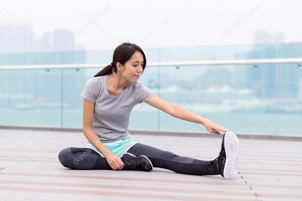 sporty woman stretching at outdoor