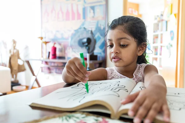 Indian girl doing drawing on book — Stock Photo, Image