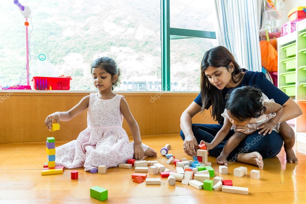 Indian family play with toy blocks