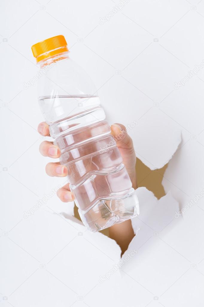 female hand with bottle of water