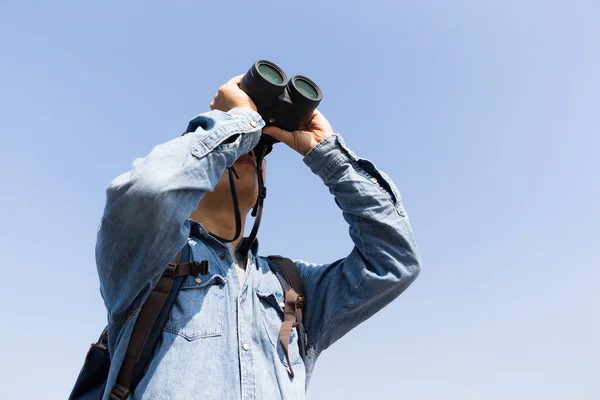 Young Man looking though binoculars — Stock Photo, Image