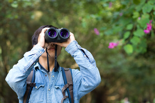 Young Man watching though binoculars
