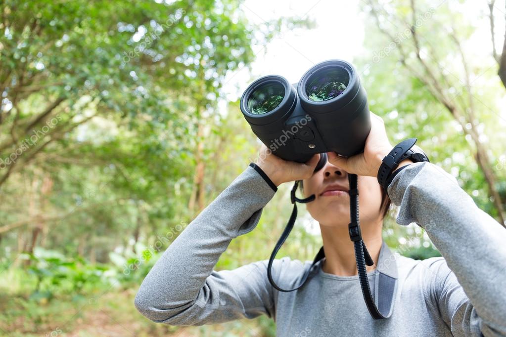 Asian young woman using binoculars