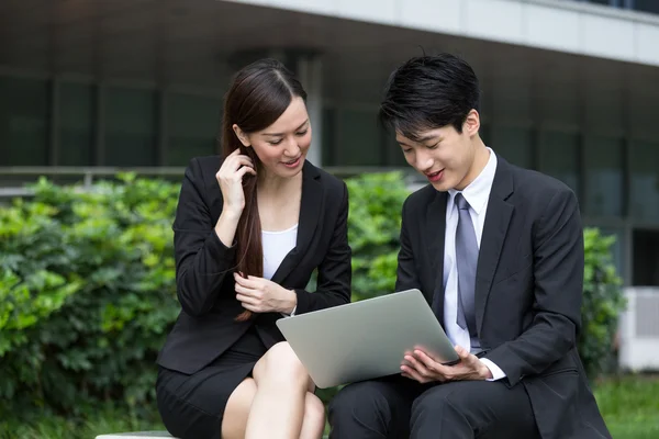 Businesswoman and businessman using laptop — Stock Photo, Image