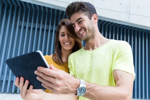 Couple using digital tablet at outdoor — Stock Photo, Image