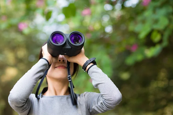 Žena hledá i když binokulárního — Stock fotografie