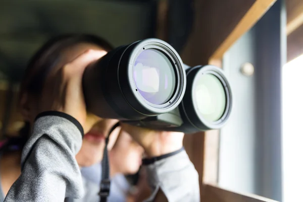 Asian woman using binoculars for birdwatching — Stock Photo, Image