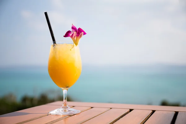 Glass of orange juice on wooden table — Stock Photo, Image