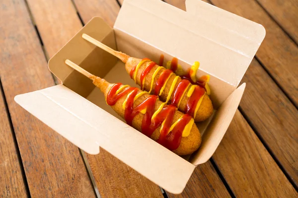 Corn dogs in paper box — Stock Photo, Image