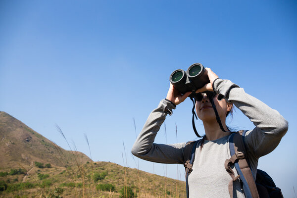 Woman looking though binocular
