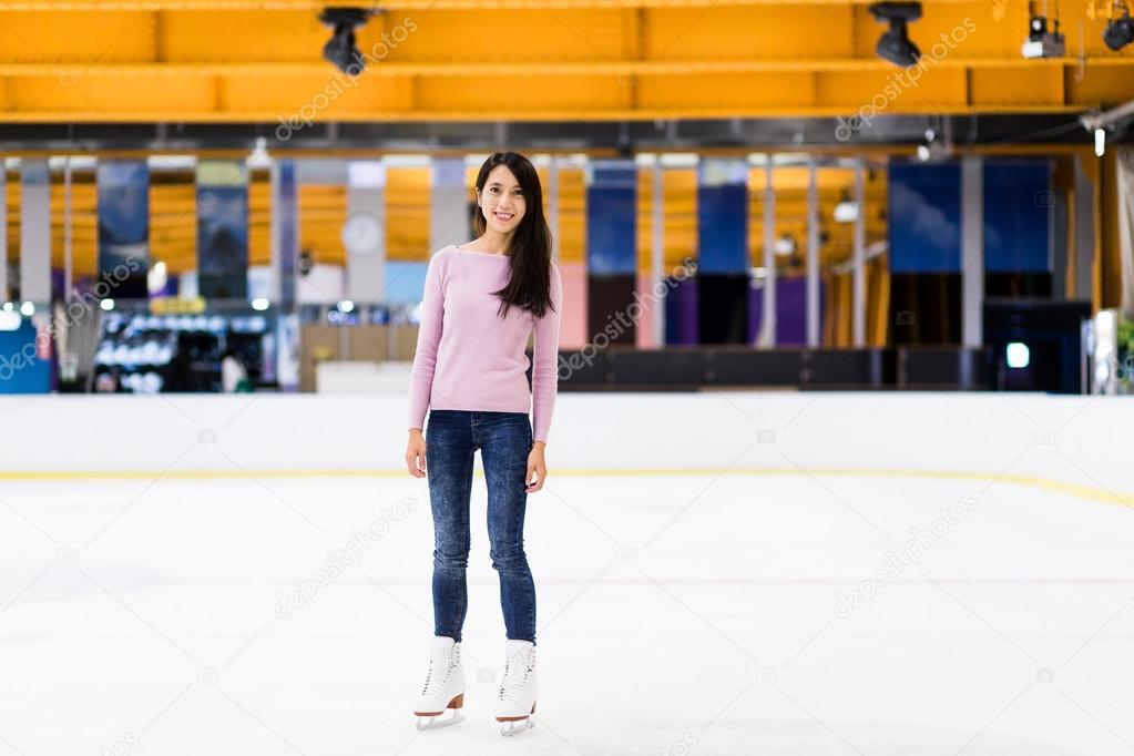 Asian woman skating on ice rink