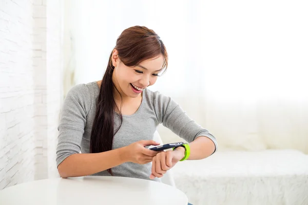 Verbinding met smartphone en wearable horloge vrouw — Stockfoto