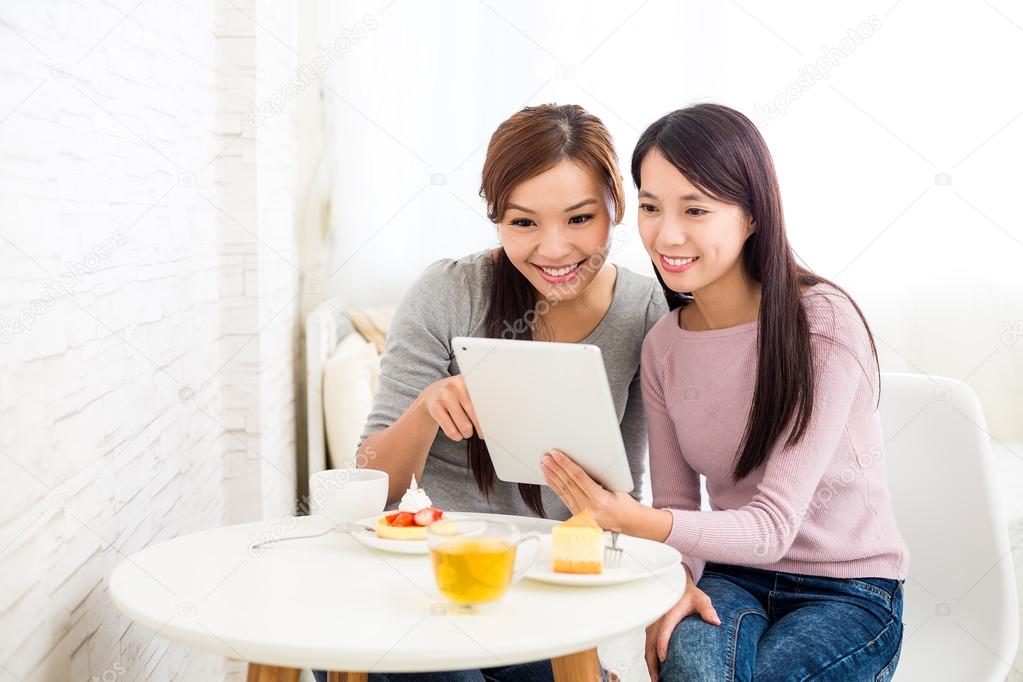 Two women using digital tablet pc