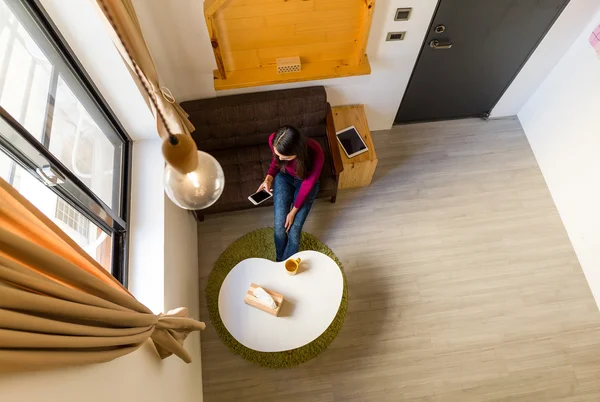 Woman using mobile phone at home — Stock Photo, Image