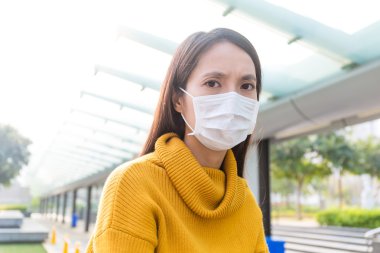 Asian woman sick and wearing face mask clipart