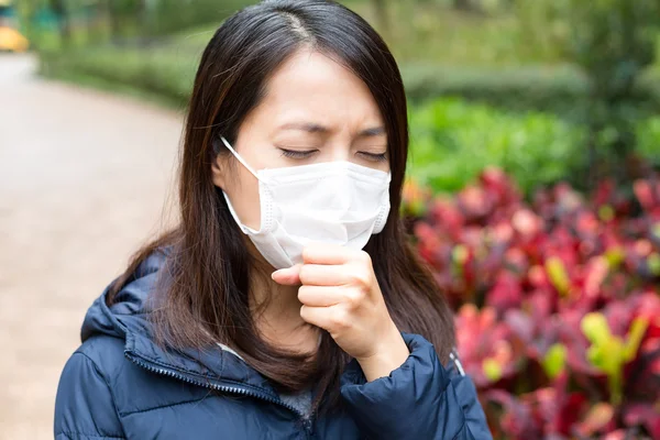 アジアの若い女性の病気および身に着けているマスク — ストック写真