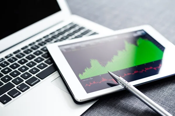 Stock market graphs on tablet pc — Stock Photo, Image