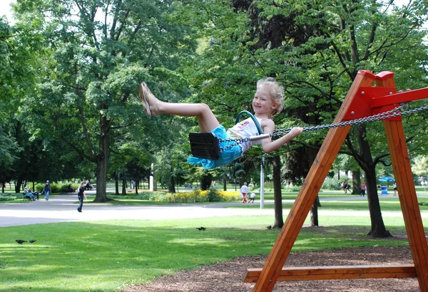 The little girl on a swing — Stock Photo, Image