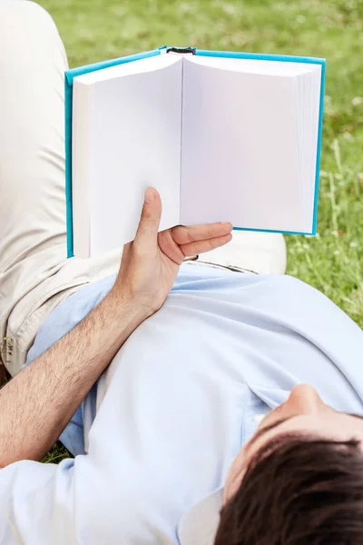 一个男人在公园看书的剪下来的照片 — 图库照片