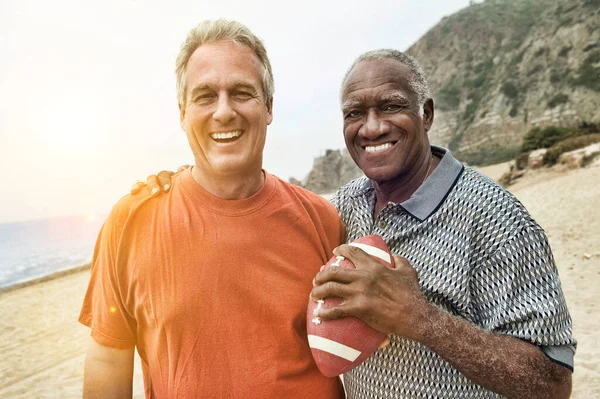 Portrait Two Multi Ethnic Mature Male Friends Beach Holding Football — Stock Photo, Image