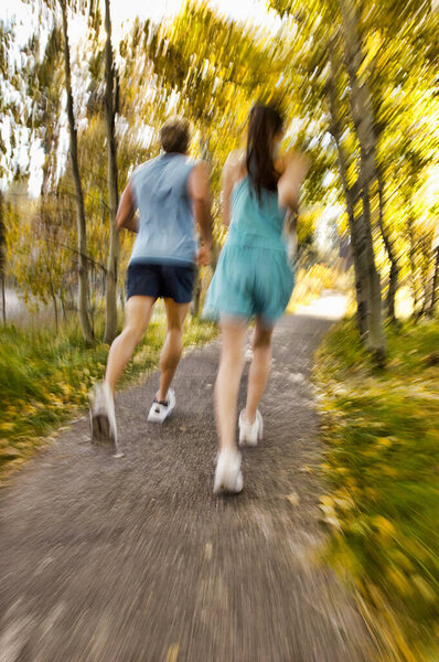 Rear View Young Couple Jogging Forest Stock Photo