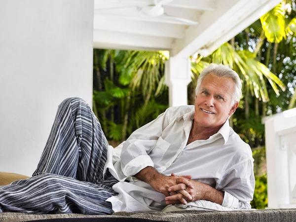 Portrait Smiling Mature Man Reclining Verandah — Stock Photo, Image