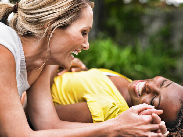 Female Multi Ethnic Friends Laughing Together Garden Stock Photo