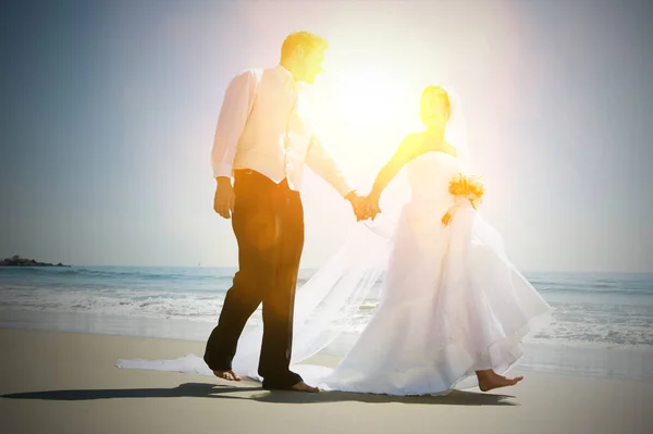 全长新婚夫妇手牵手在沙滩上散步 — 图库照片