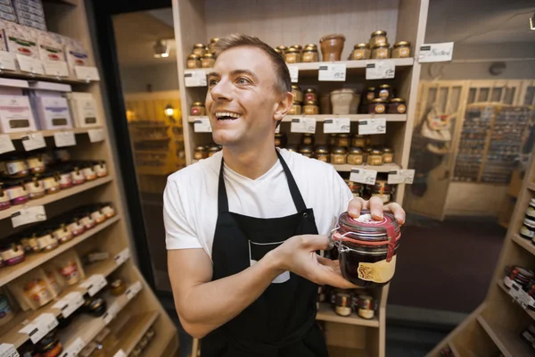 Salesman holding jar of jam — Stock Photo, Image